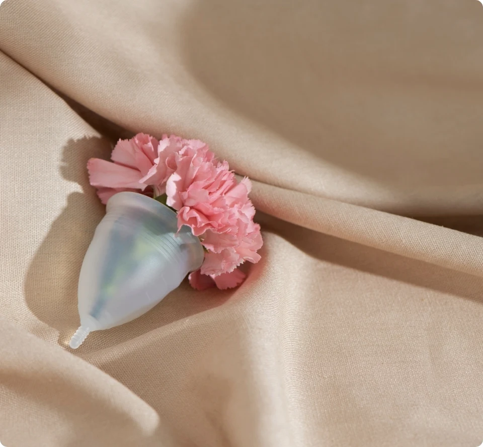 Clear Kallypso menstrual cup on soft fabric